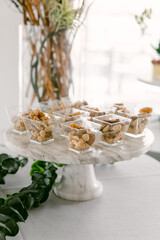 Dessert cups featuring assorted nuts and toppings displayed elegantly at a modern event in bright daylight