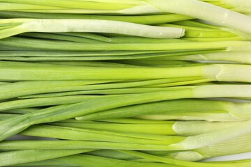 Fresh green onions as background, top view