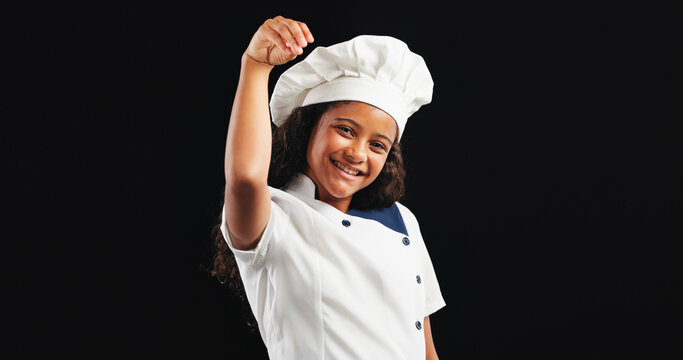 Happy girl, portrait or chef with sprinkle for adding ingredients or final touch on a dark studio background. Female person, teenager or young cook with smile or salt for culinary art on mockup space