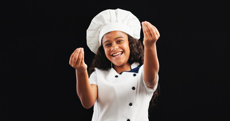 Happy, portrait and child with chef costume in studio for halloween, imagination or career day. Role play, smile and girl with dress up for culinary artist with approval gesture by black background.