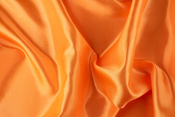 Elegant Golden Satin Fabric with Soft Waves and Reflective Sheen, silk background.