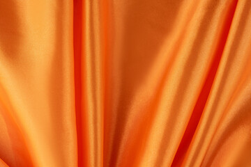 Luxurious Orange Satin Fabric with Smooth and Shiny Finish. Silky background.