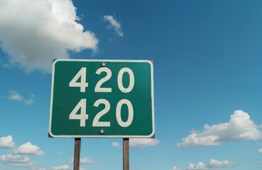 Sign with 420 text, cannabis leaves on it against sky. Concept of cannabis legalization, pot culture, celebration of the 420 holiday. Recreational or medical marijuana.