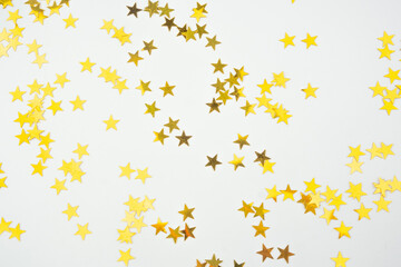 Golden Star Confetti on White Background.