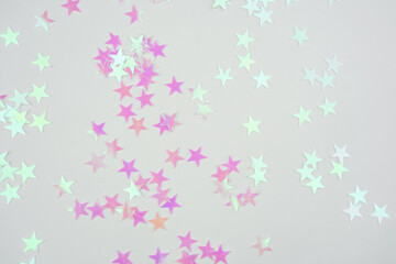 Pink and Holographic Star Confetti on White Background.