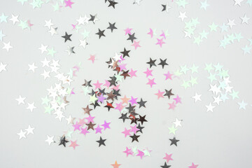Pink and Holographic Star Confetti on White Background.