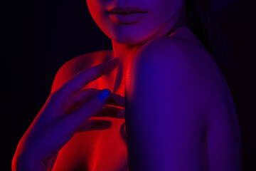Female silhouette in red and blue lighting highlighting smooth skin