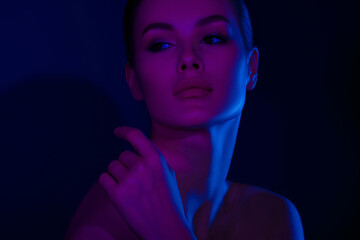 Young caucasian female in purple and blue dramatic lighting portrait