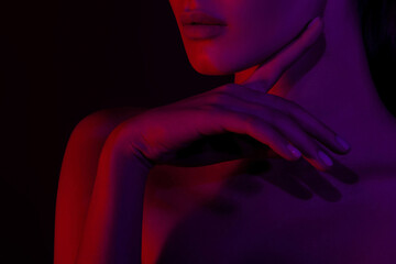 Female silhouette in red and purple light, artistic close-up