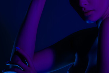 Female silhouette in moody purple and blue lighting