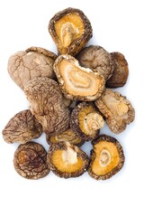 Dried shiitake mushrooms arranged on a pure white background, emphasizing detailed textures and natural colors.