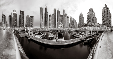 Fototapeta premium Skyscrapers and Urban city skyline over water, black and white style, city background, Dubai Marina bay UAE