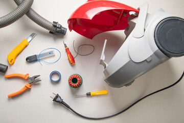 Broken vacuum cleaner and tools. Vacuum cleaner repairing