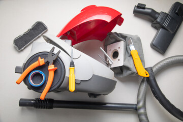 Broken vacuum cleaner and tools. Vacuum cleaner repairing