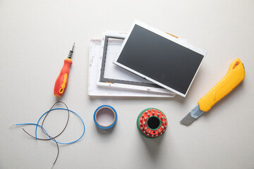 Various tools and broken tablet. Tablet repair