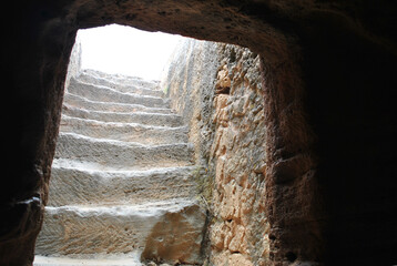 photo of old stone stairs running up towards the light