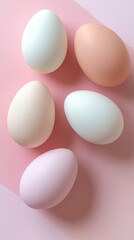 Colorful eggs arranged on a pastel pink background in a visually appealing display, perfect for Easter festivities or creative projects