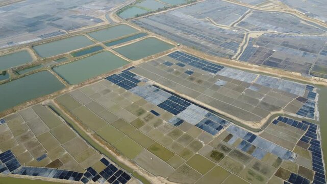 Sea salt process at rural area of Bangladesh. Raw material of salt industrial. White salt harvesting. Agriculture industry. Aerial view of salt farm, Landscape and environment. Harvesting salt.