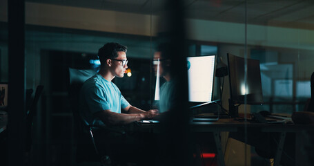 Overtime, screen or man on computer for startup report, post deadline or online update research. Engagement, night or content strategist on monitor for digital marketing trends or social media growth