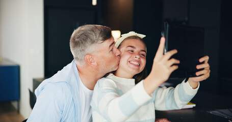 Fototapeta premium Dad, daughter and kiss with cheek for selfie, photography or picture together at home. Happy girl, father and teenager with smile, love or tablet in joy for memory, bonding or social media at house