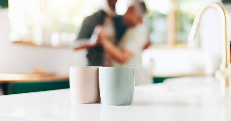 Morning, coffee and mug of couple in kitchen for caffeine beverage, warm drink and cappuccino. Marriage, home and man and woman dance, bonding and embrace with cups on counter for breakfast together