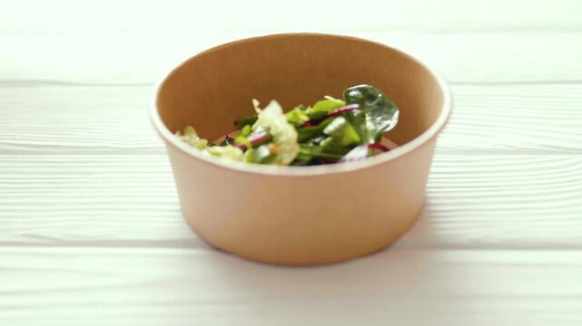 Closeup of fresh healthy salad in a a zero waste container to go. Food delivery, healthy food concept.