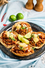 Traditional Mexican Tacos al Pastor with Fresh Lime and Salsa on a Rustic Table