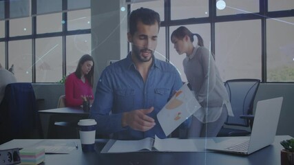 Man in office holding document with network connections animation overlay