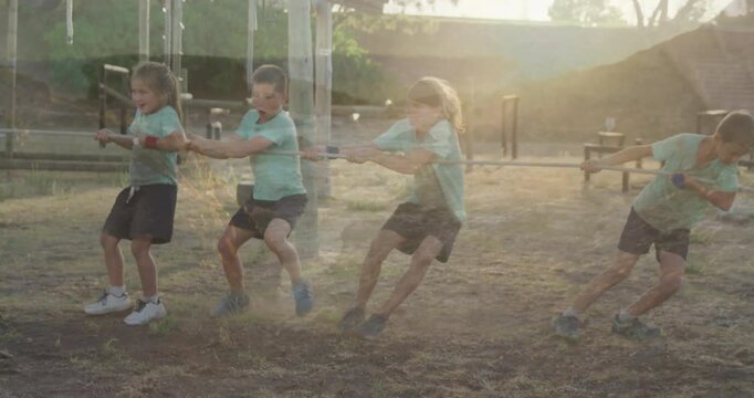 In school, children playing tug-of-war with animation of sunlight creating glow
