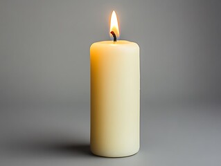 A lit candle burning brightly with an illuminating warm glow