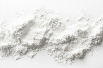 Fototapeta premium White powder, possibly flour or powdered sugar, scattered in a textured wave pattern on a white background.