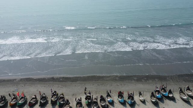 Aerial View of fishing at Cox's bazar Sea Beach in Bangladesh. Traditional colorful fishing boats along the shoreline on the beach on Teknaf, Cox's Bazar, Chittagong, Bangladesh