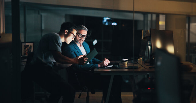 Overtime, teamwork or business people on tablet for finance, economic news or investment growth. Mentorship, night or financial analyst on technology for research, stocks report or trading account