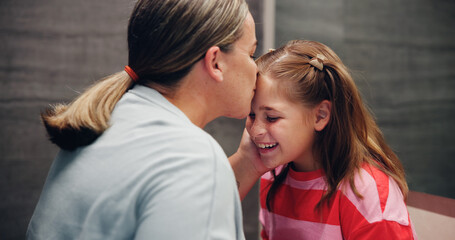 Mother, child and kiss on forehead in home for love, support and daughter bonding together with parent. Mom, girl and affection with kid for care, connection and happiness with family for motherhood