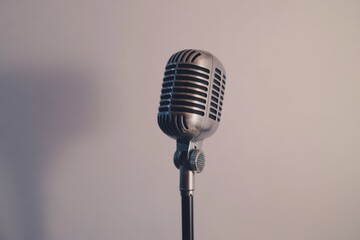 A vintage microphone stands against a plain background ready for a performance or recording session