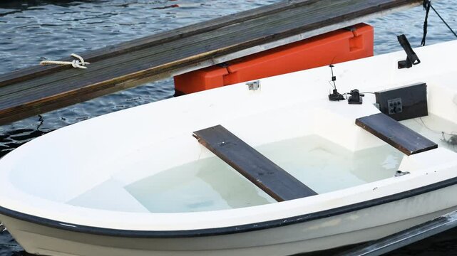 White plastic boat half full of water