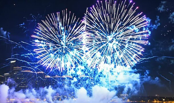 Electric blue and purple fireworks display with symmetrical visual effects