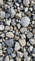 Close-up of coarse granite gravel, showing varied tones and textures, hard, rock