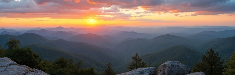 Fototapeta premium Panoramic view of Blue Ridge Mountains at sunset. Colorful sky, silhouettes mountains ranges, green trees, rocks. Golden hour scenery horizon. Perfect outdoor nature travel background.