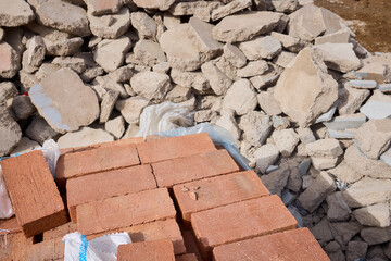There are numerous piles of concrete debris observable at the busy construction site right now