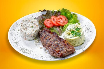 Beef steak with potatoes and rice in isolated white background