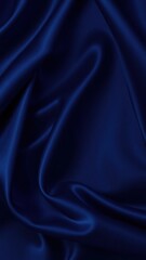 Obraz premium Abstract blue black background. Navy blue silk satin texture background. Beautiful soft wavy folds on shiny fabric. Dark elegant background for your design.