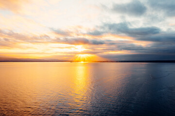 Golden Hour Majesty: Aerial Sunset Over Poolbeg Towers and Lighthouse, Dublin Skyline Aglow with Sun Rays and Coastal Charm