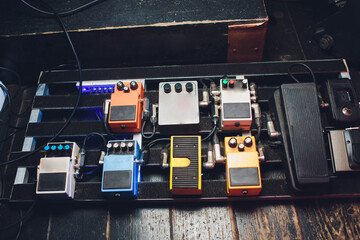 A Unique Collection of Guitar Effects Pedals Carefully Arranged on an Effect Board
