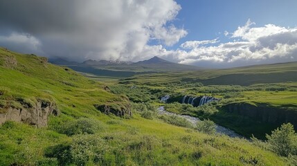 Fototapeta premium Serene Icelandic landscape with lush green hills and distant snow-capped mountain