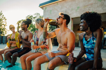 Friends enjoying drinks by the pool during summer vacation
