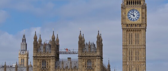 big ben London panorama golden clock blue sky parliament Westminster England climbing man on roof