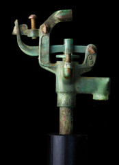 Vintage copper lawn sprinkler, corroded to the color green by oxidation