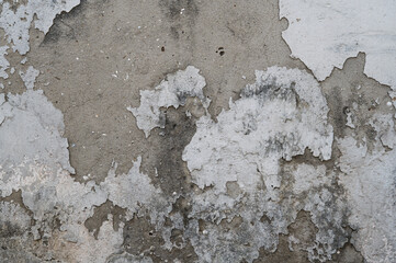 A weathered concrete wall with peeling white and gray paint, revealing layers of decay and rough textures. The abstract patterns create a distressed and urban aesthetic.