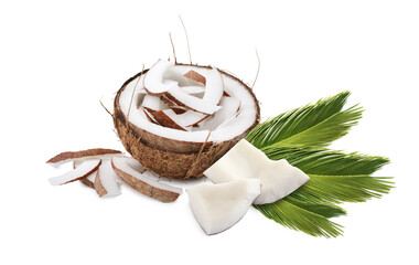 Coconut pieces and green palm leaves isolated on white
